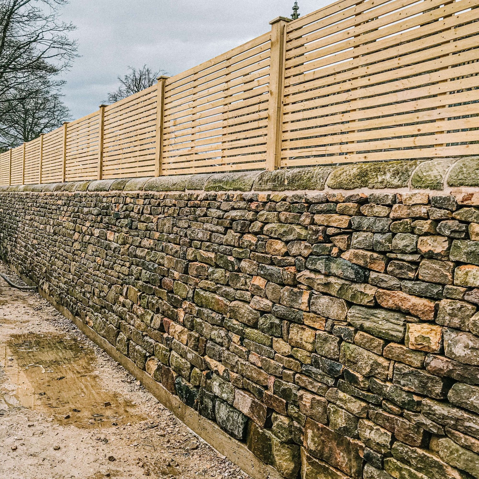 A dry stone walling - A picture of a boundary retaining dry stone wall with fence in Stannington in Sheffield